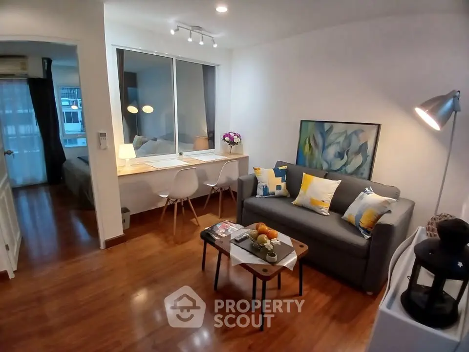 Modern living room with stylish decor and open layout, featuring cozy seating and elegant lighting.