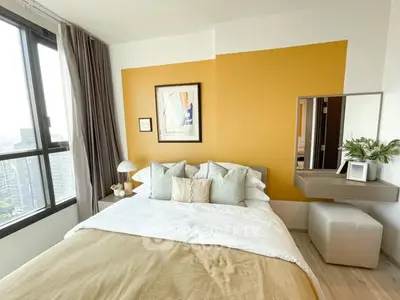 Modern bedroom with vibrant accent wall and city view