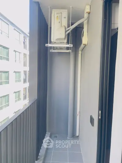 Modern apartment balcony with air conditioning unit and sleek design.