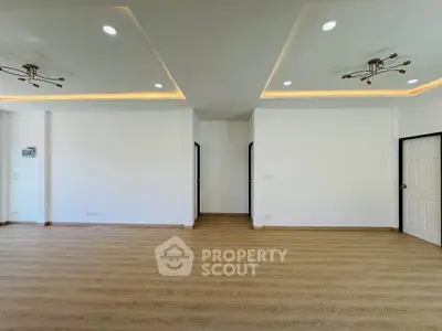 Spacious modern living room with elegant lighting and wooden flooring