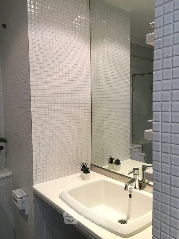 Modern bathroom with sleek white tiles and stylish sink