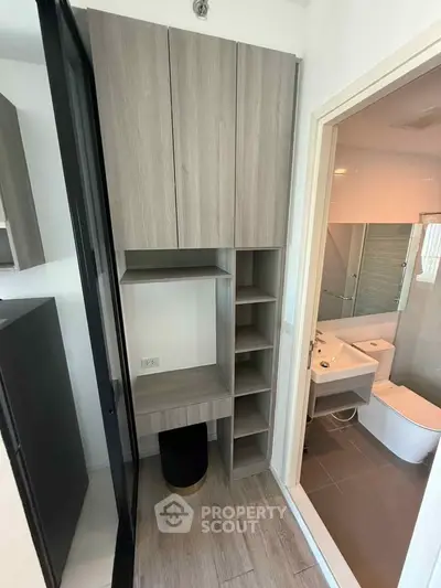 Modern bathroom with sleek wooden cabinetry and contemporary fixtures