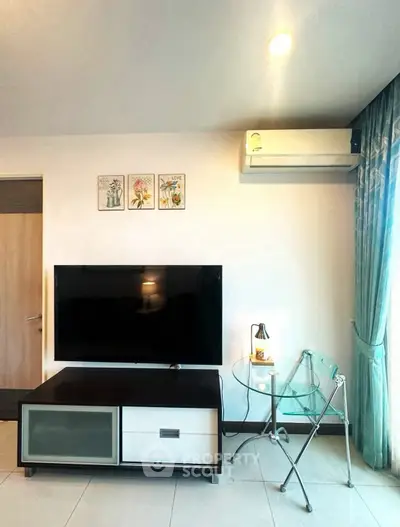 Modern living room with TV, air conditioning, and stylish decor.