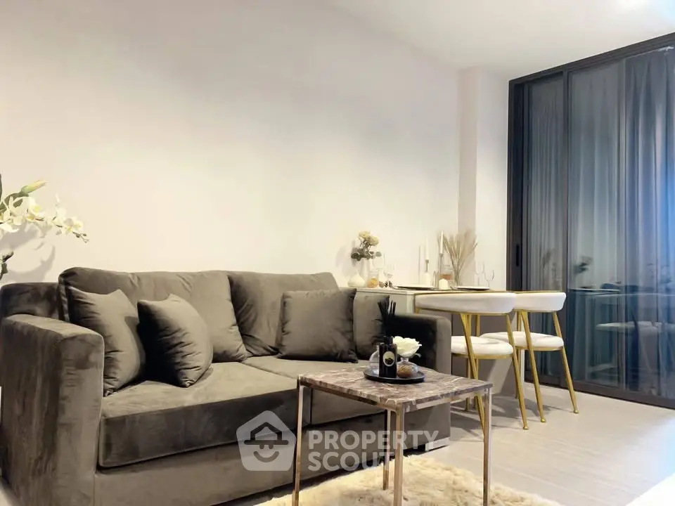 Modern living room with plush gray sofa and elegant dining set