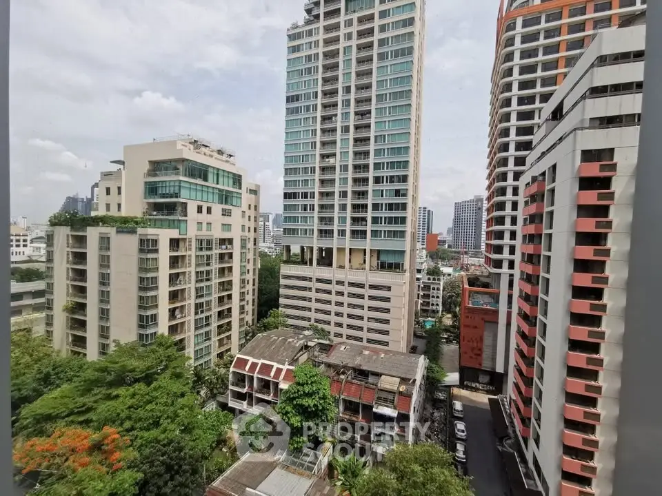 Stunning cityscape view of modern high-rise buildings and lush greenery, perfect for urban living enthusiasts.
