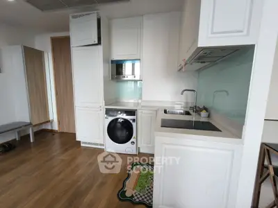 Modern kitchen with integrated washing machine and sleek cabinetry
