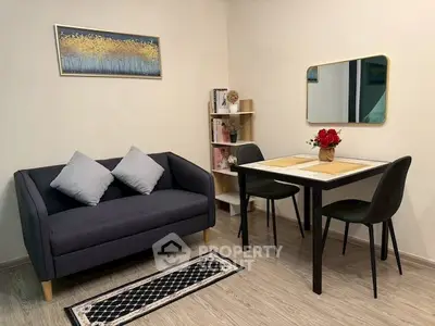 Cozy living room with modern decor and dining area, perfect for urban living.