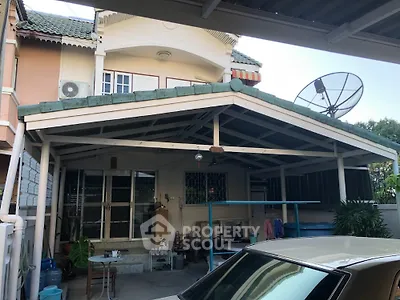 Charming suburban house with covered carport and satellite dish, ideal for family living.
