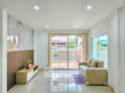 Spacious living room with modern decor and large windows for natural light.