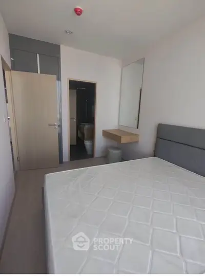 Modern minimalist bedroom with sleek design and ample natural light