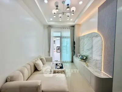 Elegant living room with modern lighting and marble accent wall