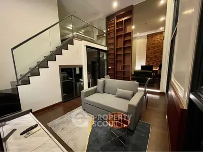 Modern living room with stylish staircase and cozy seating area in a contemporary apartment.
