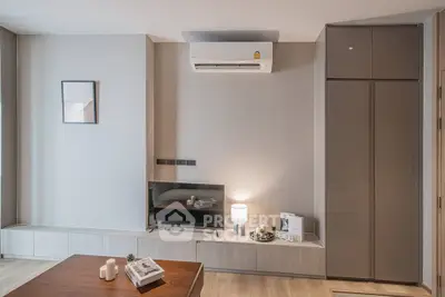 Modern living room with sleek design, featuring air conditioning and stylish decor.