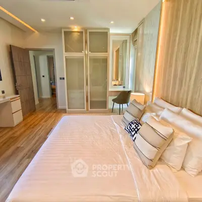 Luxurious bedroom with modern design, featuring a spacious bed and elegant decor.