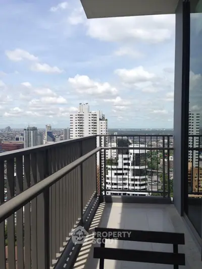 Stunning high-rise balcony view with cityscape and clear skies