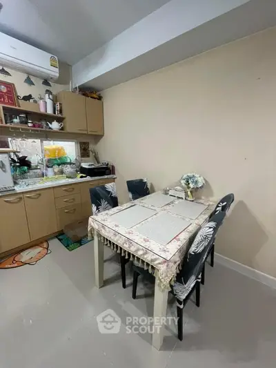 Cozy kitchen with dining table and modern appliances in a compact layout.