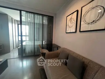 Modern living room with glass partition and stylish decor