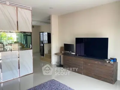Modern living room with sleek TV setup and stylish furniture in a contemporary home.