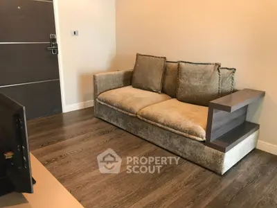 Modern living room with plush sofa and sleek wooden flooring