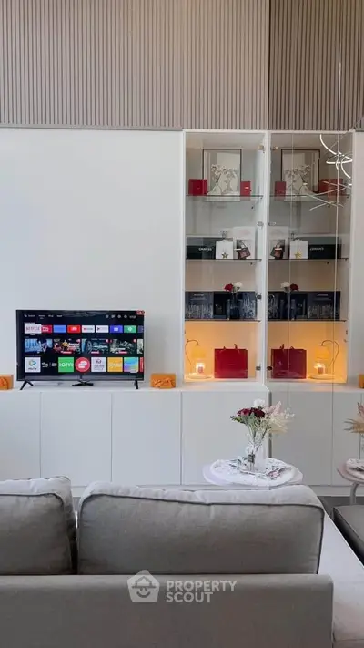 Modern living room with sleek TV setup and elegant shelving unit, perfect for stylish urban living.
