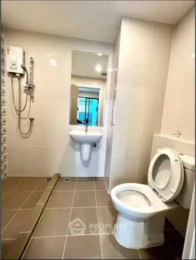 Modern bathroom with sleek fixtures and walk-in shower in a contemporary home.