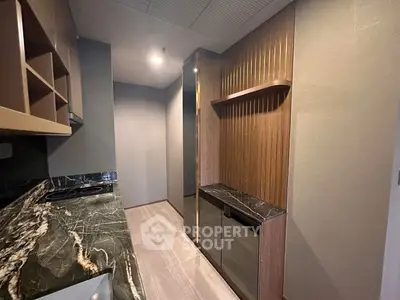 Modern kitchen with sleek marble countertops and closed layout design.