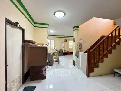 Spacious living area with staircase and modern lighting in a cozy home