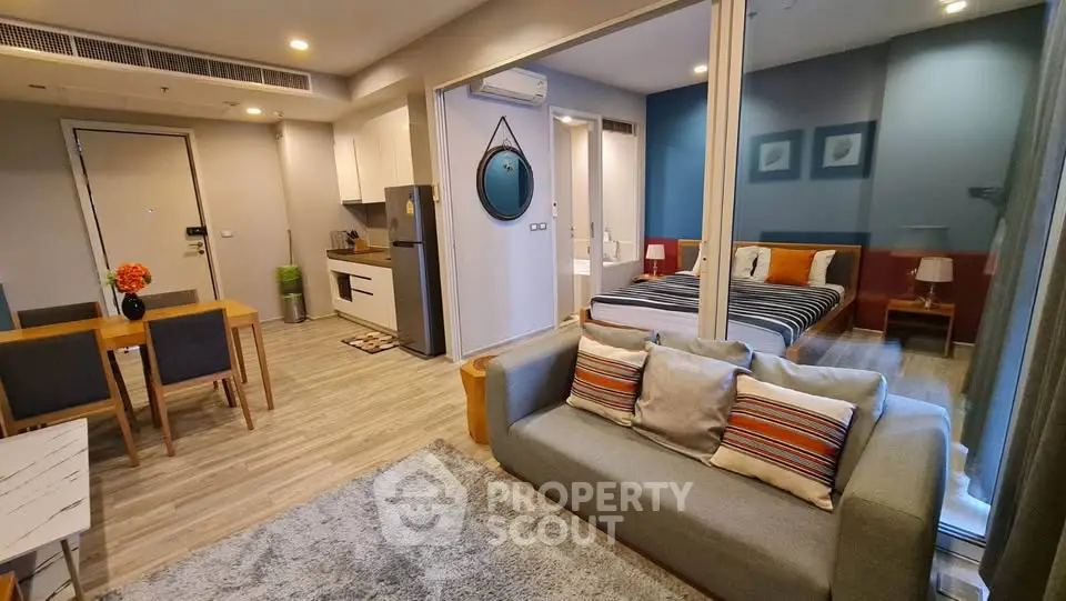 Modern open-plan living room with kitchen and bedroom in stylish apartment
