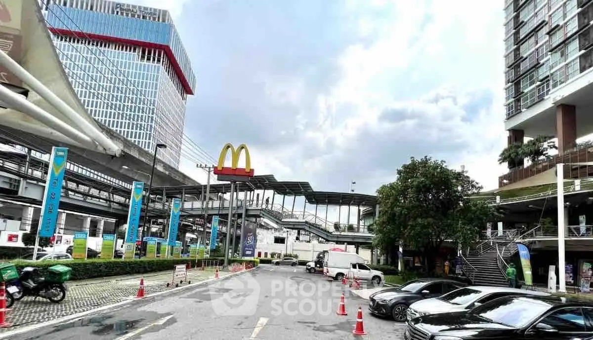 Modern urban street view with commercial buildings and parking area
