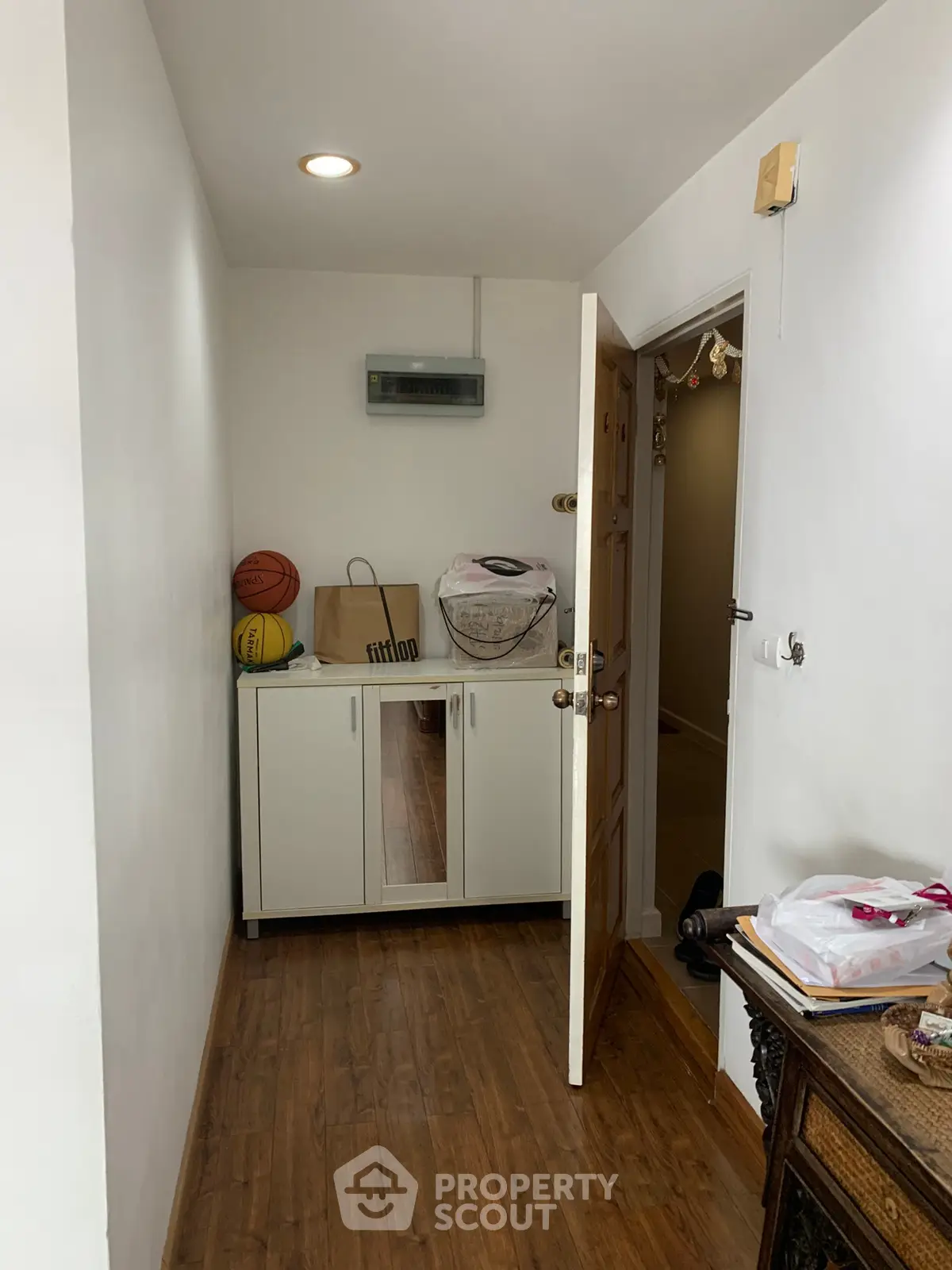 Cozy storage area with wooden flooring and cabinet, perfect for organizing essentials.