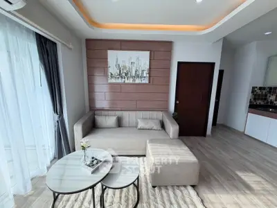 Modern living room with stylish decor and cozy seating area in a contemporary apartment.