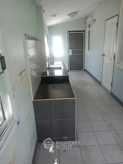 Spacious kitchen with sleek countertops and ample natural light