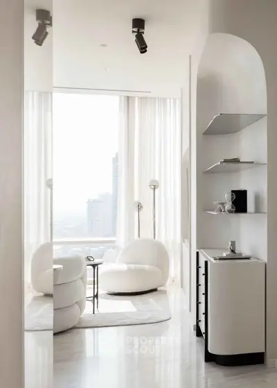 Luxurious modern living room with panoramic city view and elegant white furniture.