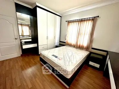 Spacious bedroom with natural light and modern furnishings