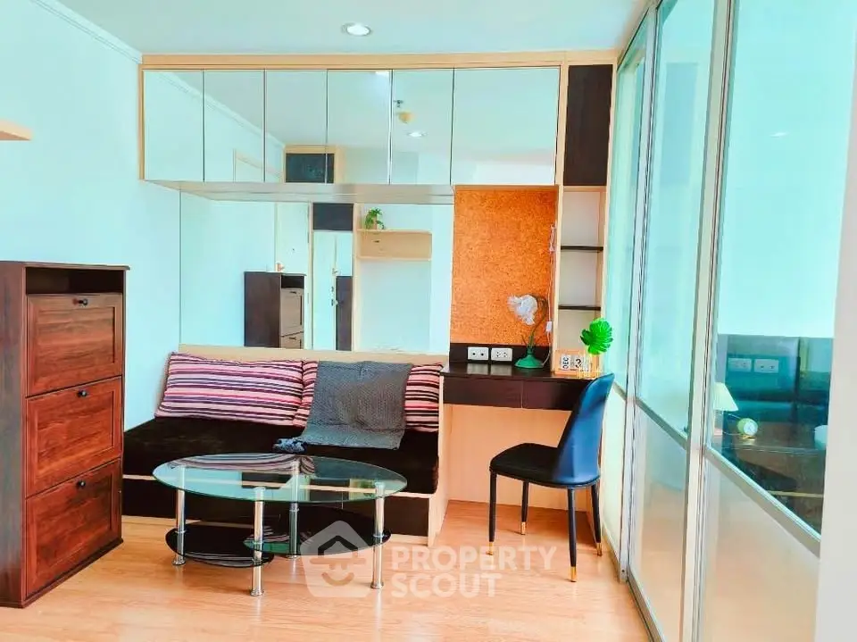 Modern living room with stylish furniture and mirrored wall in a cozy apartment.