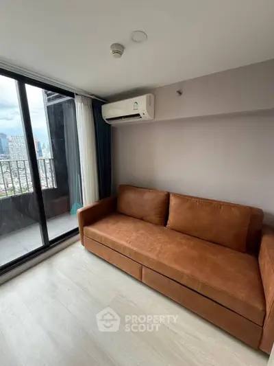 Modern living room with brown sofa and city view balcony