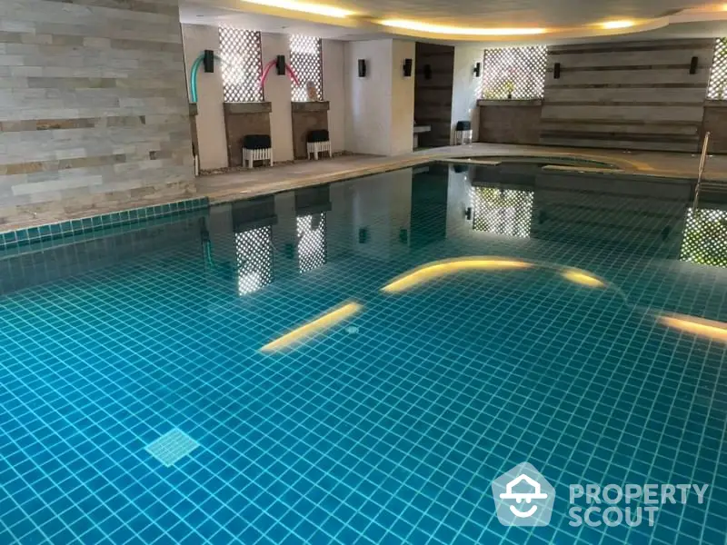 Luxurious indoor swimming pool with modern design and ambient lighting