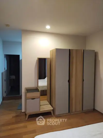 Modern bedroom with stylish wardrobe and vanity in a cozy apartment