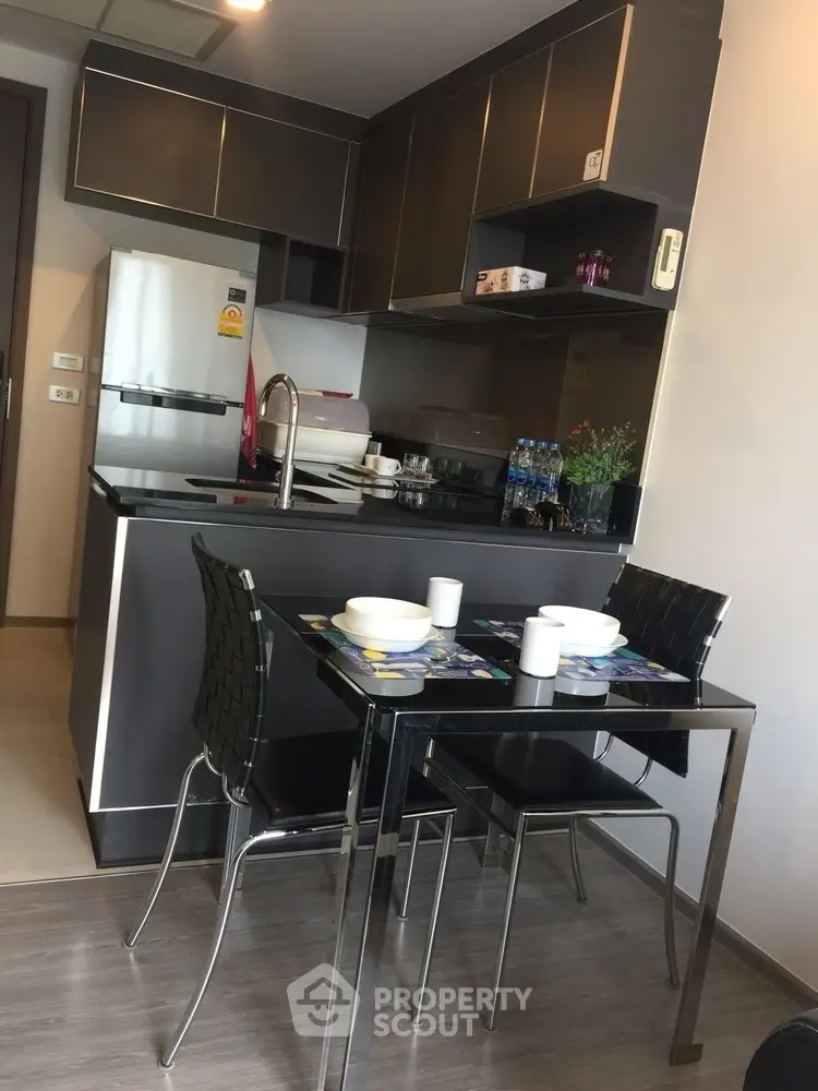 Modern kitchen with sleek cabinets and dining area in stylish apartment