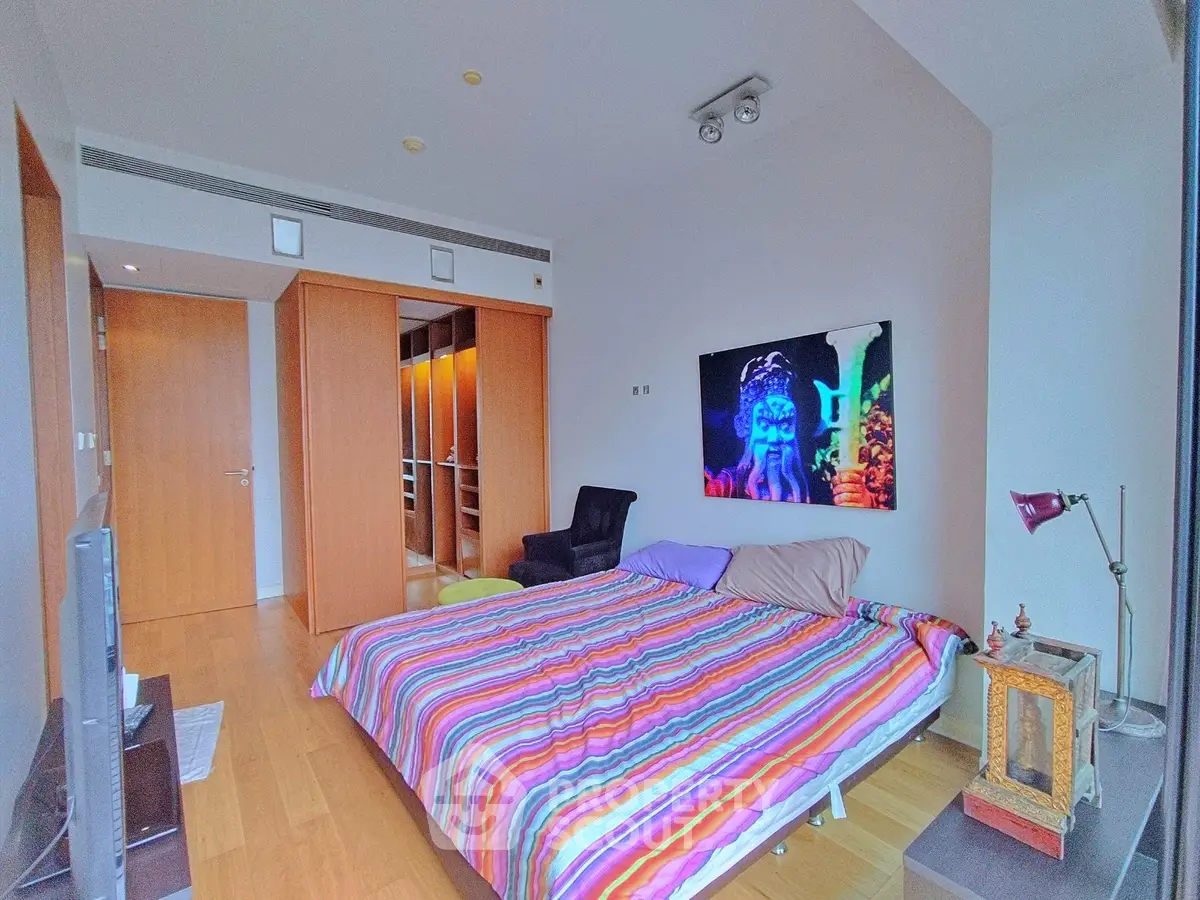 Spacious bedroom with colorful bedding and modern decor