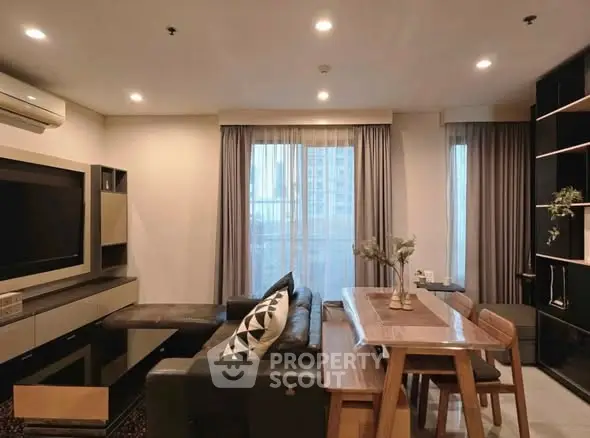 Modern living room with stylish furniture and large windows in a cozy apartment.