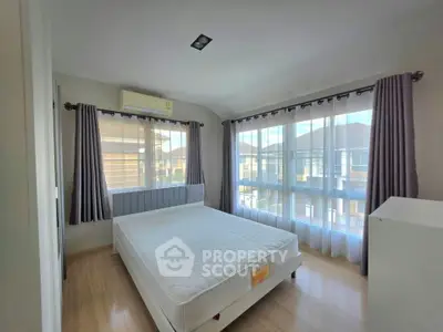 Bright and airy bedroom with large windows and modern decor