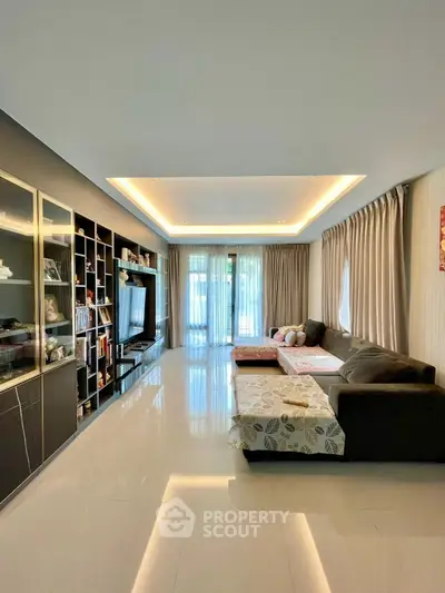 Spacious modern living room with sleek design and large windows for natural light.