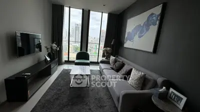 Modern living room with city view, sleek furniture, and stylish decor in high-rise apartment.