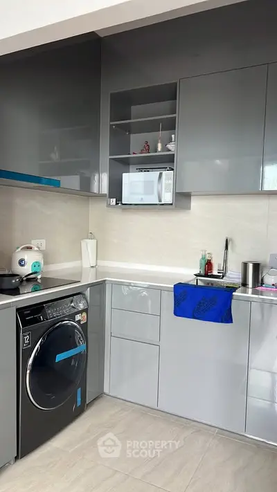 Modern kitchen with sleek grey cabinets and built-in appliances