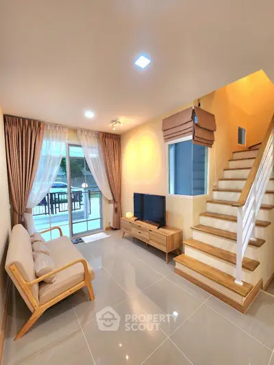 Modern living room with elegant staircase and large windows