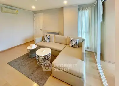 Spacious living room with modern L-shaped sofa and stylish decor in a bright apartment.
