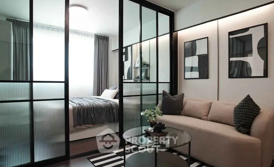 Modern studio apartment with glass partition, cozy sofa, and stylish decor