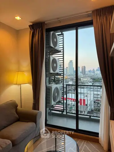 Cozy living room with city view from balcony, featuring elegant curtains and modern decor.