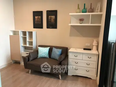 Cozy living room with modern decor, featuring a stylish sofa, elegant shelving, and chic wall art.